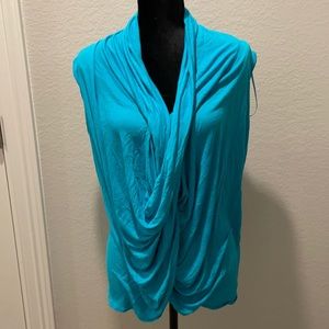 Jennifer Lopez: Twist front aqua blue sleeveless shirt
